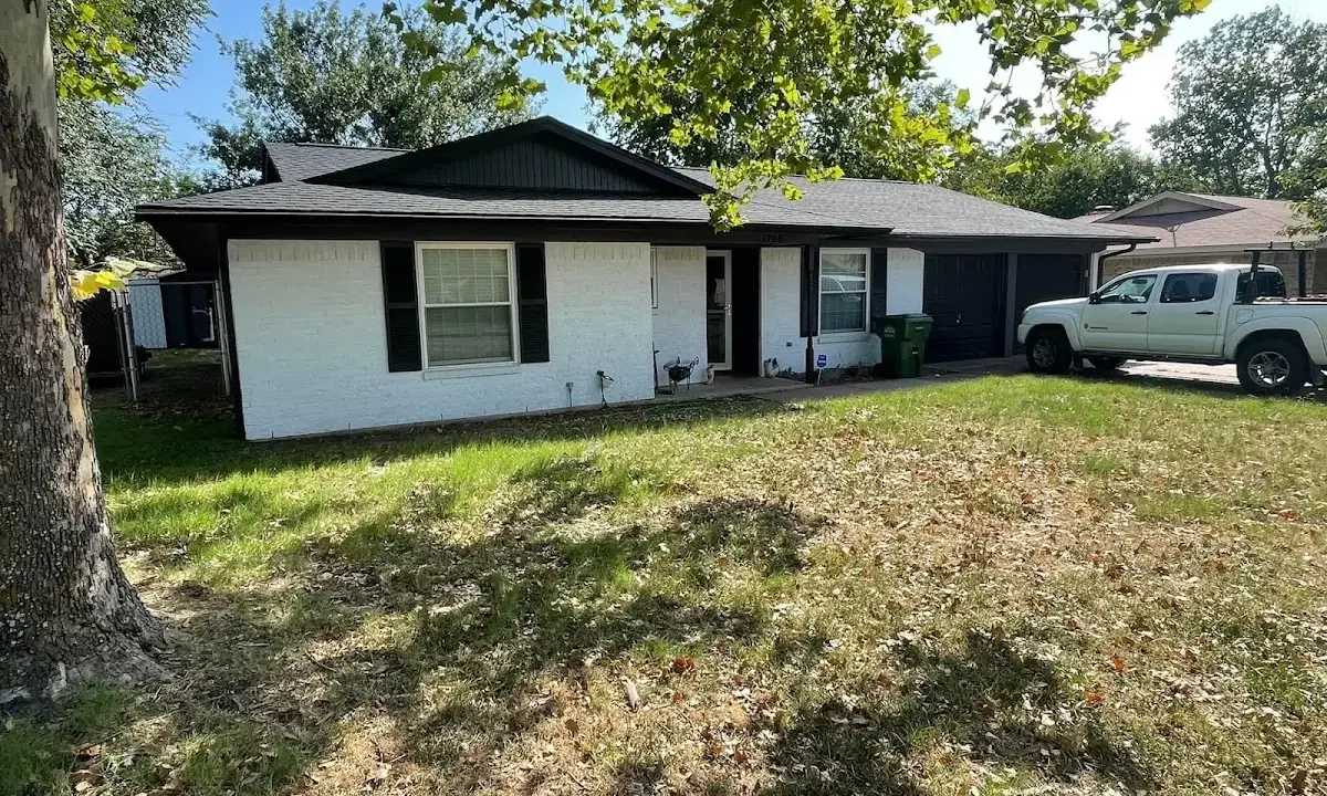 Professional roofing crew working on a residential roof in Millburn